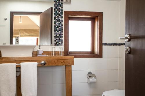a bathroom with a sink and a mirror at Casa Kalfu Hotel Boutique in Puerto Varas