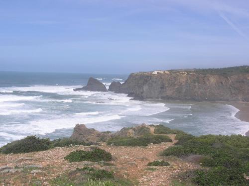 a view of a beach with rocks and the ocean at Moradia Rossio,11 in Odeceixe