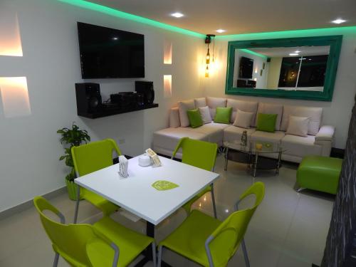 a living room with a couch and a table and chairs at Apartment Lux Bocagrande in Cartagena de Indias