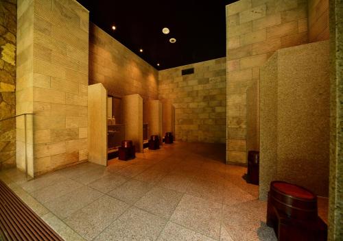a hallway of a building with a row of stalls at Balinese onsen ryokan Hakone Airu in Hakone