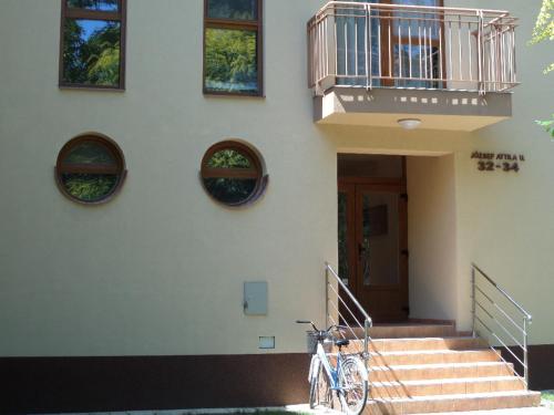 a bike parked on the side of a building at Rex Apartman in Hajdúszoboszló