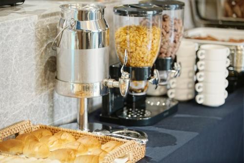 a table with a food processor and a basket of bread at Stanford Hotel Busan in Busan