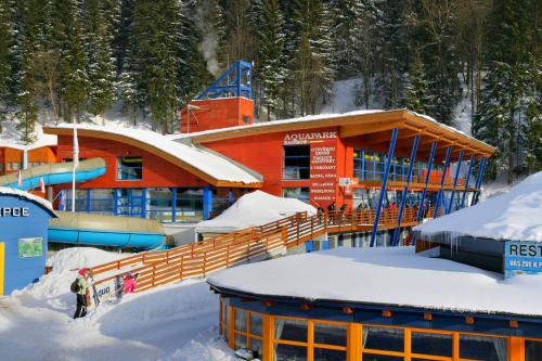 a ski resort in the snow in front of a building at Resort Špindl in Špindlerův Mlýn