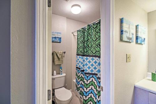 a bathroom with a toilet and a shower curtain at Marina Townhouse at Oak Glenn in Ocean Springs