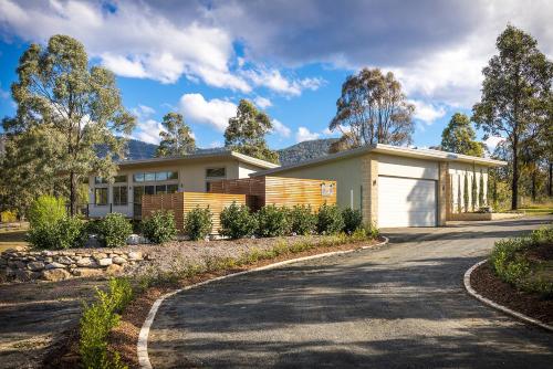 a house with a driveway in front of it at Blue Cliff Retreat in Pokolbin