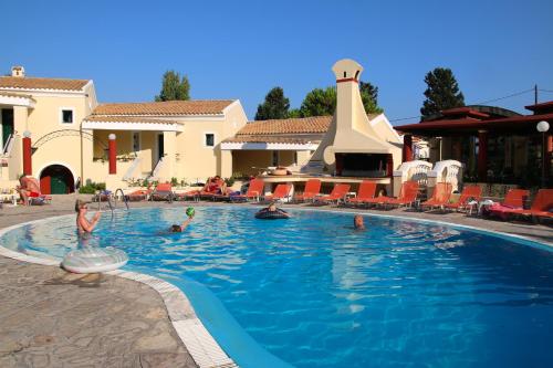 a group of people swimming in a swimming pool at Mediterranean Blue in Kavos