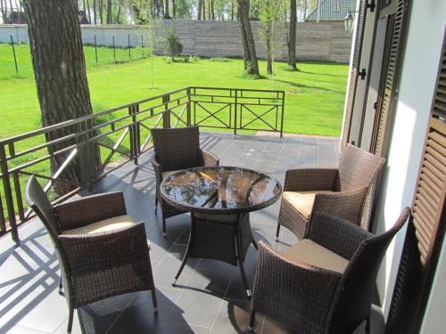 a patio with chairs and a table on a balcony at Park-Hotel Kidev in Chubynske