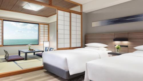 a bedroom with two beds and a large window at Nanki-Shirahama Marriott Hotel in Shirahama