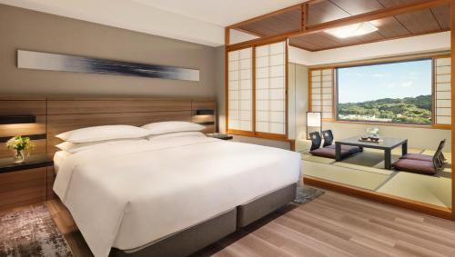 a bedroom with a large white bed and a window at Nanki-Shirahama Marriott Hotel in Shirahama