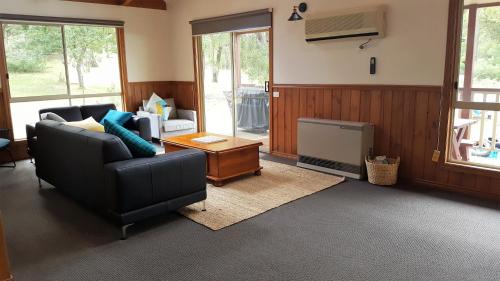 a living room with a couch and a table at Holiday Heights in Halls Gap