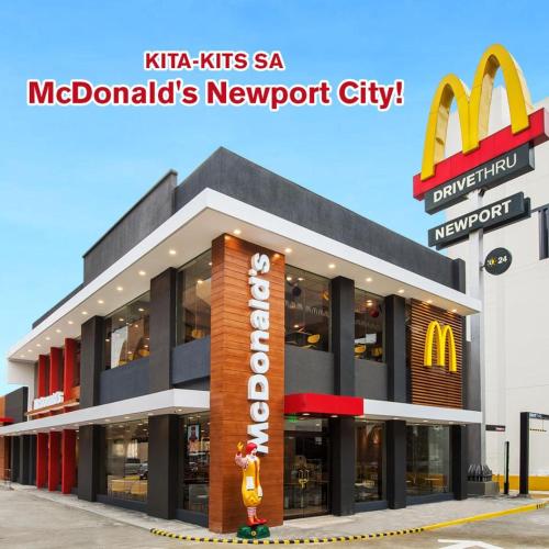 a mcdonalds restaurant with a mcdonalds newport city sign at One Palm Tree Villas in Manila