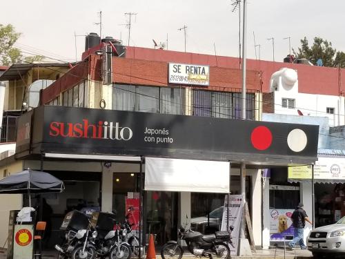 a store with motorcycles parked in front of a building at Casa Q BnB in Mexico City
