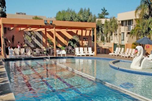 a pool at a hotel with swans in the water at Number 72 Kalbarri Riverview Apartments in Kalbarri