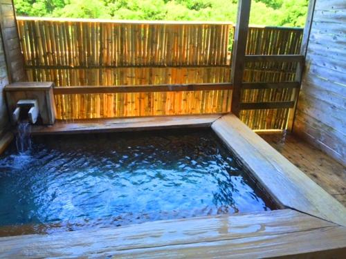 a pool of water in a wooden enclosure at Seiryuso in Misasa