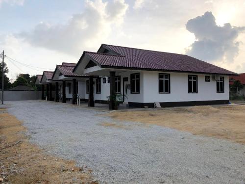 a white house with red roof at Twin Homestay A in Kuala Terengganu