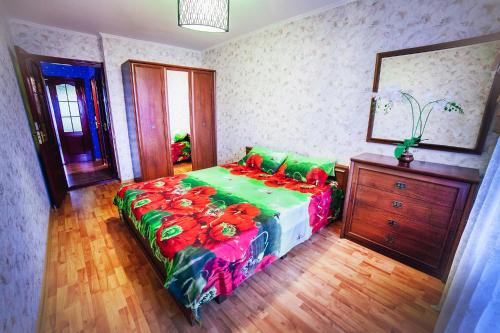 a bedroom with a bed and a dresser at 2-bedroom on Mykolaychuka street in Vinnytsya