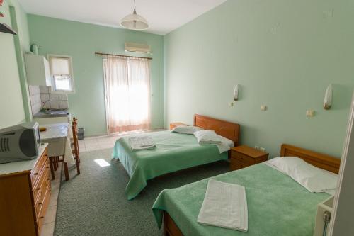 מיטה או מיטות בחדר ב-Costa-Rini Hotel