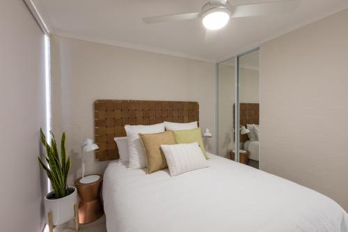 Number 72 Kalbarri Riverview Apartments في كالباري: غرفة نوم بسرير ابيض كبير مع مخدات