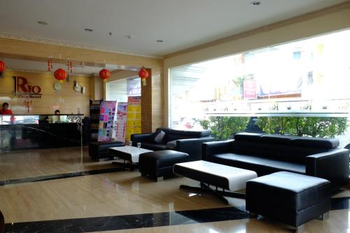 a lobby with couches and tables in a store at Rio City Hotel in Palembang