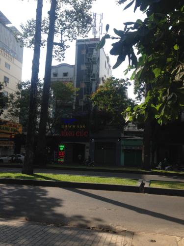 a street with trees and a building in the background at HONG CUC Hotel in Ho Chi Minh City