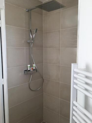 a shower with a shower head in a bathroom at Villa L'Amiraute in Agde