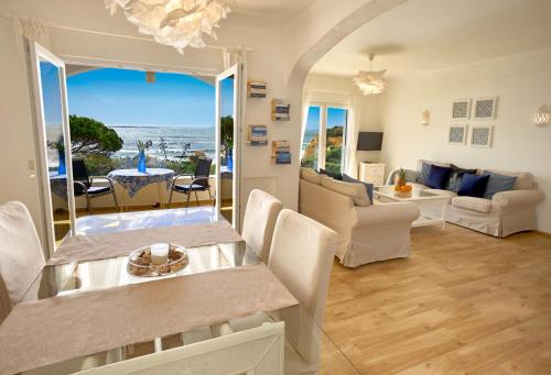 a living room with a view of the ocean at E&M Beach House Aldeamento do Levante II in Lagoa