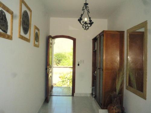 a hallway with a door and a chandelier at Hotel Portal del Santo in Cafayate