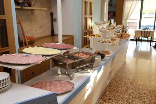 a buffet line with many different types of food at Hotel Lugano in Cattolica