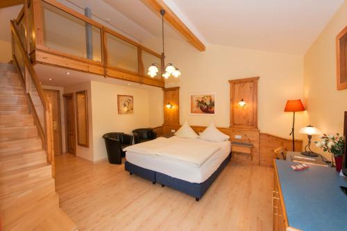 a hotel room with a bed and a staircase at Hotel Belle Vue in Vianden