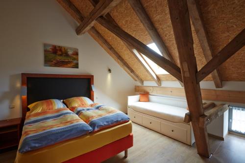 a attic bedroom with a bed and a window at Dreiseithof Sohra in Sohra