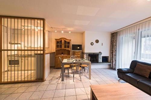 a living room with a couch and a table at Appartementhaus-Quadern in Valens