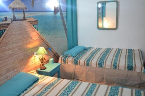 a bedroom with two beds and a view of the ocean at Residencia Santiago Mallorca in Cala Figuera