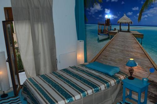 a bedroom with a bed and a wooden pier at Residencia Santiago Mallorca in Cala Figuera