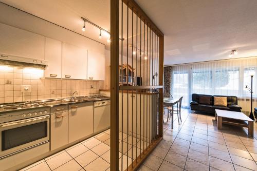 a kitchen and living room with a couch at Appartementhaus-Quadern in Valens