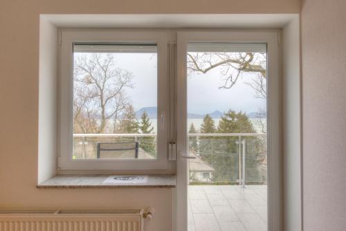 an open window with a view of a balcony at Hilltop Apartments in Fonyód