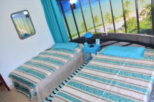 a bedroom with two beds and a window at Residencia Santiago Mallorca in Cala Figuera