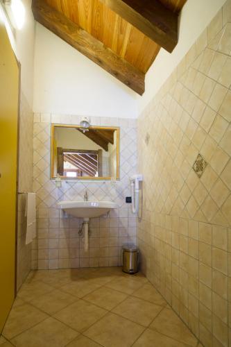 a bathroom with a sink and a mirror at Chalet Della Guida in Bardonecchia
