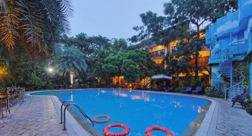 a large swimming pool in a hotel at night at Hotel Mahabs in Mahabalipuram