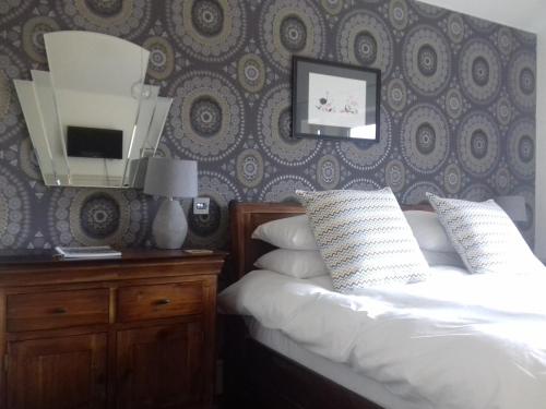 a bedroom with a bed and a tv on a wall at 40 Bernisdale - The Sabhal in Skeabost