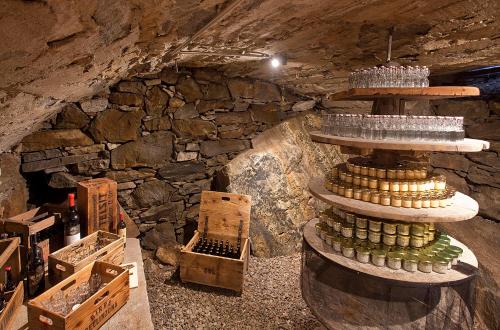 a wine cellar with a stack of wine glasses at MyVerzasca Resort Casa Rossa in Brione
