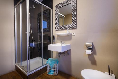 a bathroom with a sink and a shower at Hotel Santa Maria in Rotterdam