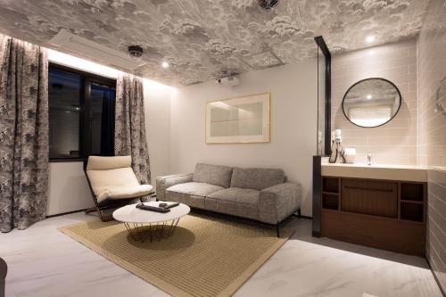 a living room with a couch and a sink at Brown-Dot Hotel Choeup in Busan