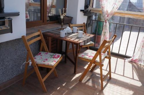 a wooden table and chairs sitting on a balcony at Bella Vista - Cosy 1BD Flat with a Big Terrace in Sofia