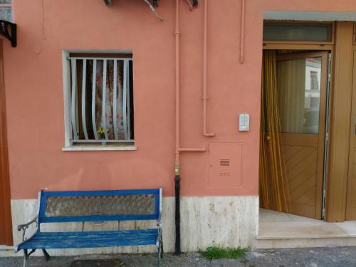 a blue bench sitting in front of a building at Dimora Marisa in Termoli