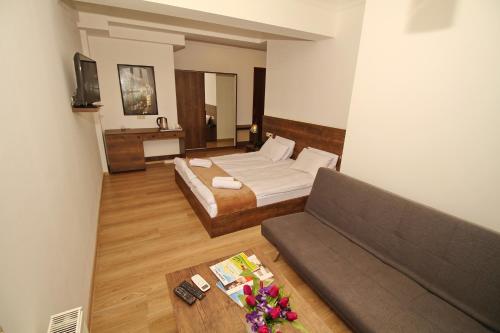 a hotel room with a bed and a couch at Tbilisi View Hotel in Tbilisi City