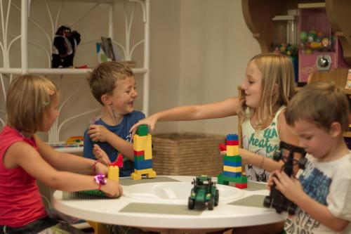 a group of children playing with blocks at a table at Hotel Wildauerhof in Walchsee