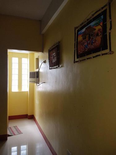 a room with a window and a painting on the wall at Mayon Lodging House in Legazpi
