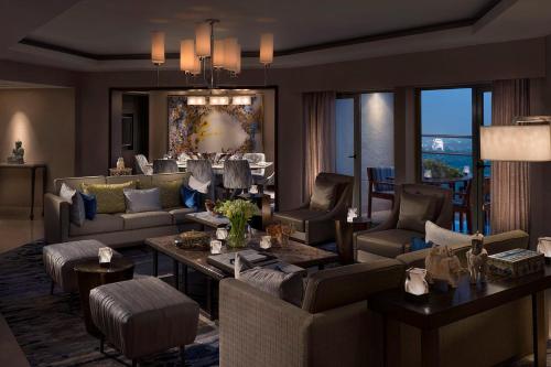 a large living room with couches and chairs at Shangri-La Eros New Delhi in New Delhi