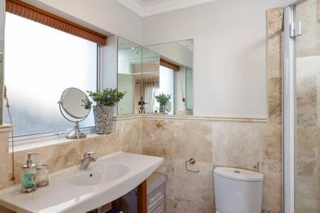 a bathroom with a sink and a mirror at WATERFRONT - Quay Largo two bedroom on the water with mooring in Knysna