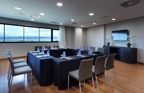 a conference room with a long table and chairs at Eurostars Madrid Foro in Tres Cantos